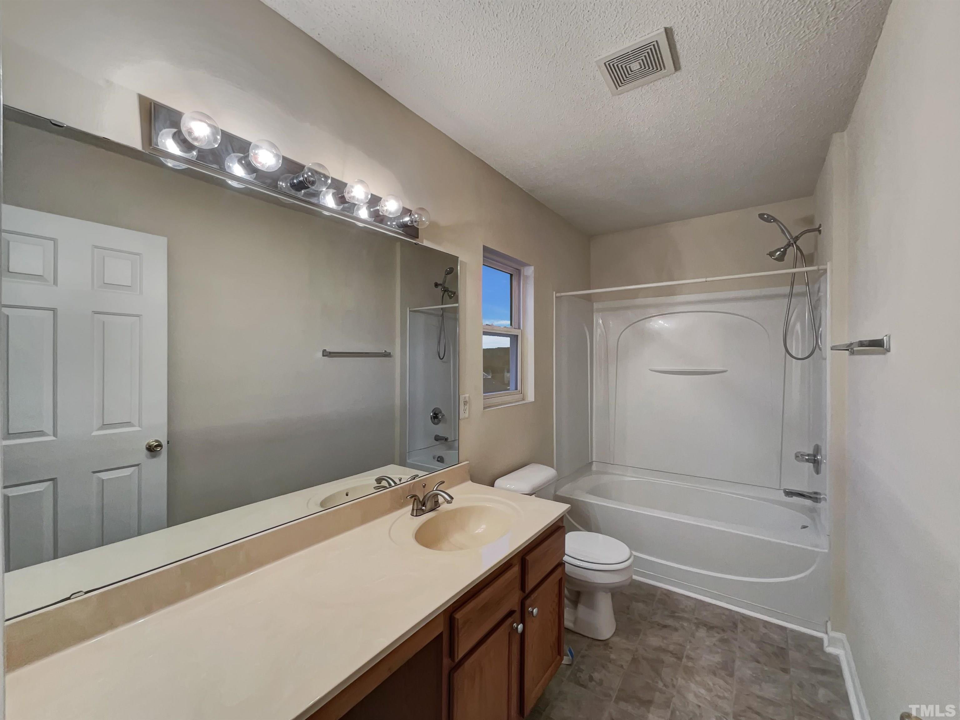 6036 Namozine Court Raleigh, NC 27610 - Photo 19 of 19 a bathroom with a sink a toilet and shower