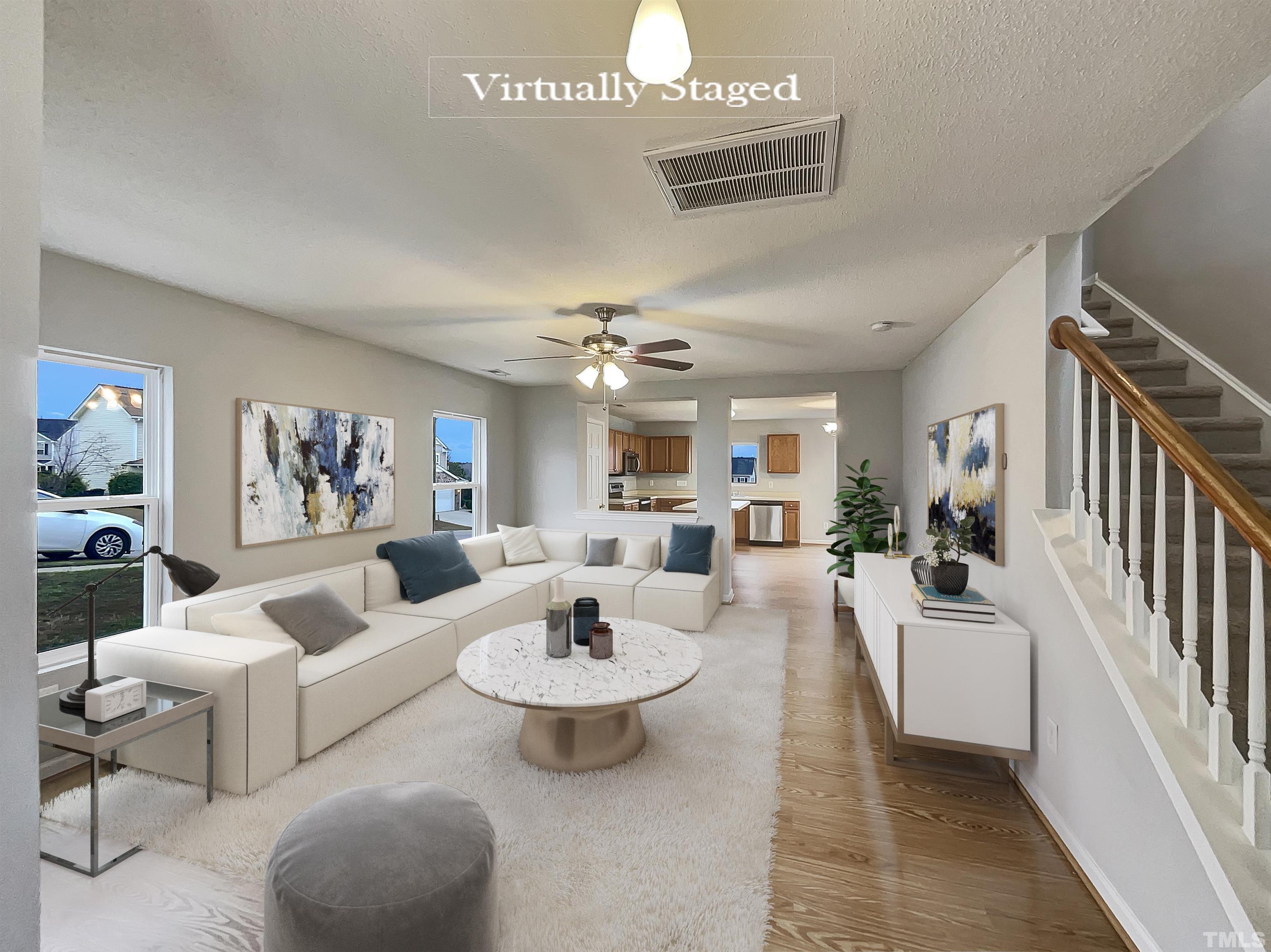 6036 Namozine Court Raleigh, NC 27610 - Photo 2 of 19 a living room with furniture and a chandelier