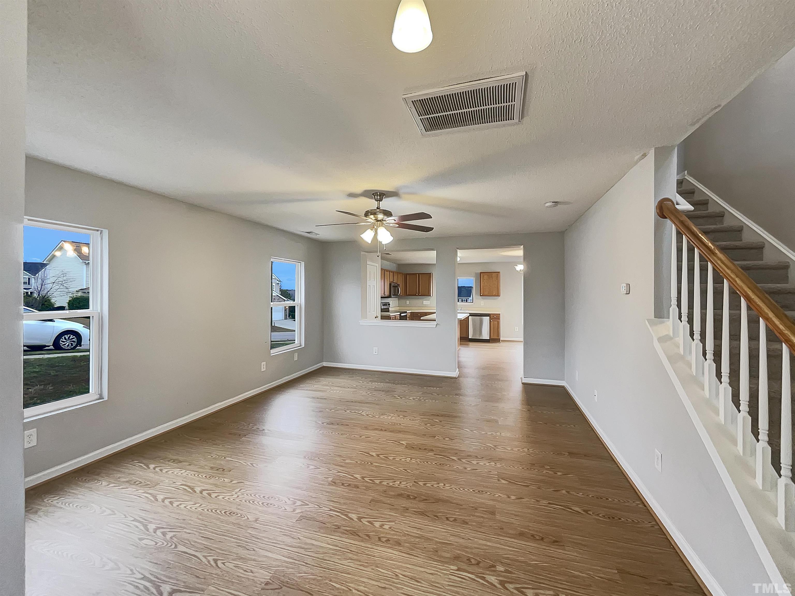 6036 Namozine Court Raleigh, NC 27610 - Photo 3 of 19 wooden floor in an empty room with a window