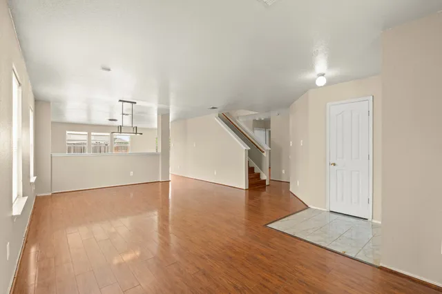 wooden floor in an empty room with a window