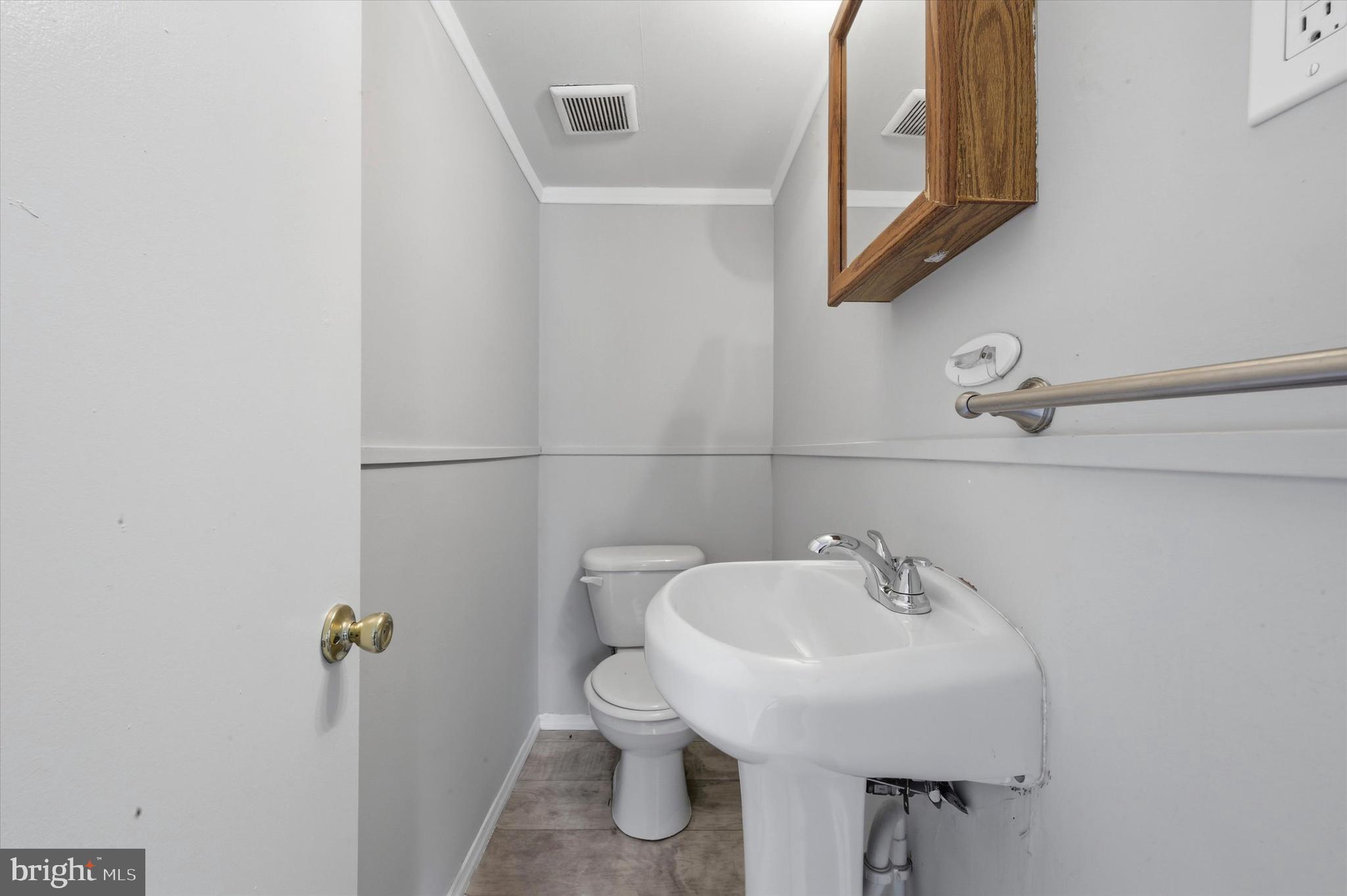 151 Chadwick Avenue Marcus Hook, PA 19061 - Photo 13 of 14 a bathroom with a sink a toilet and mirror