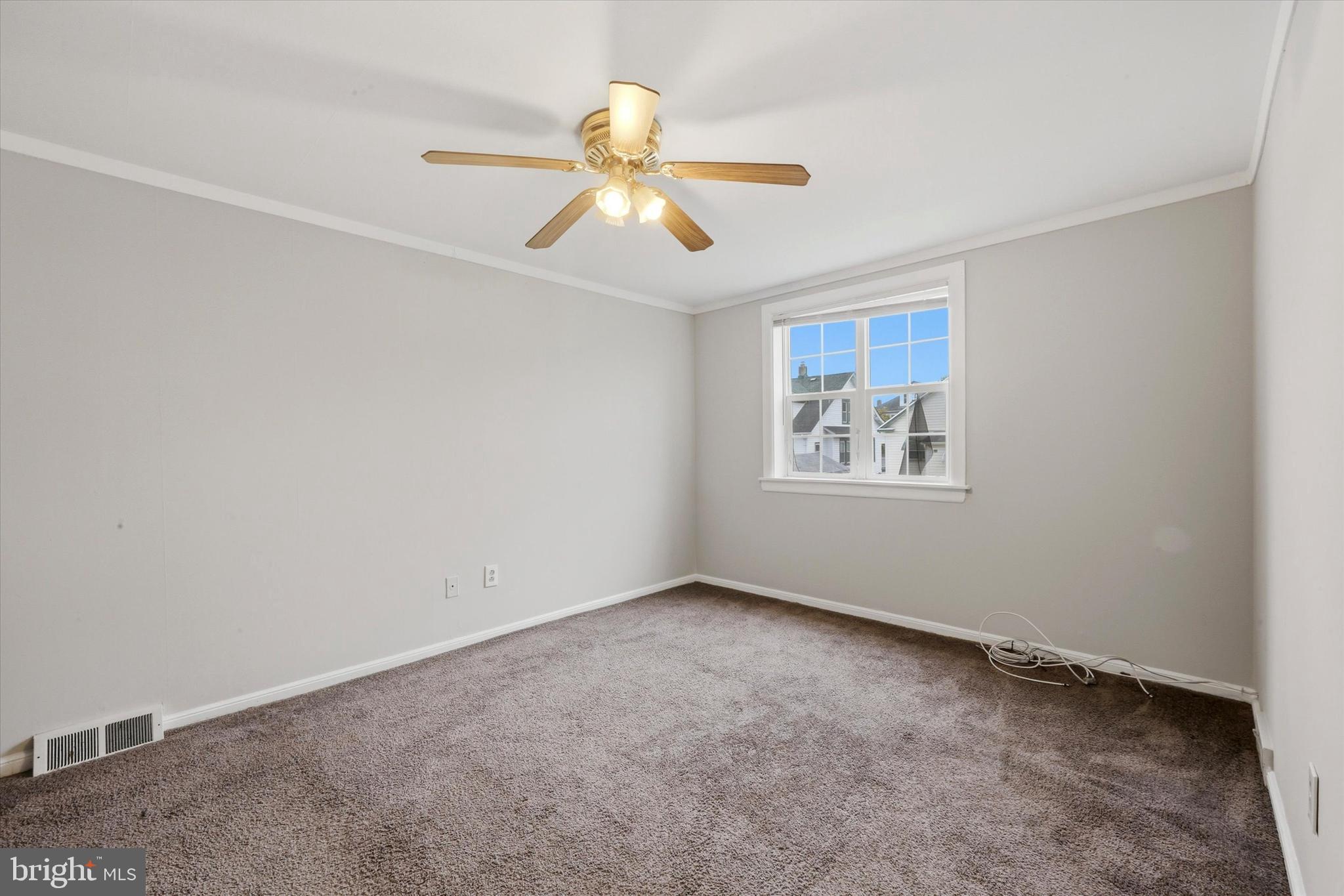 151 Chadwick Avenue Marcus Hook, PA 19061 - Photo 4 of 14 an empty room with windows and chandelier fan