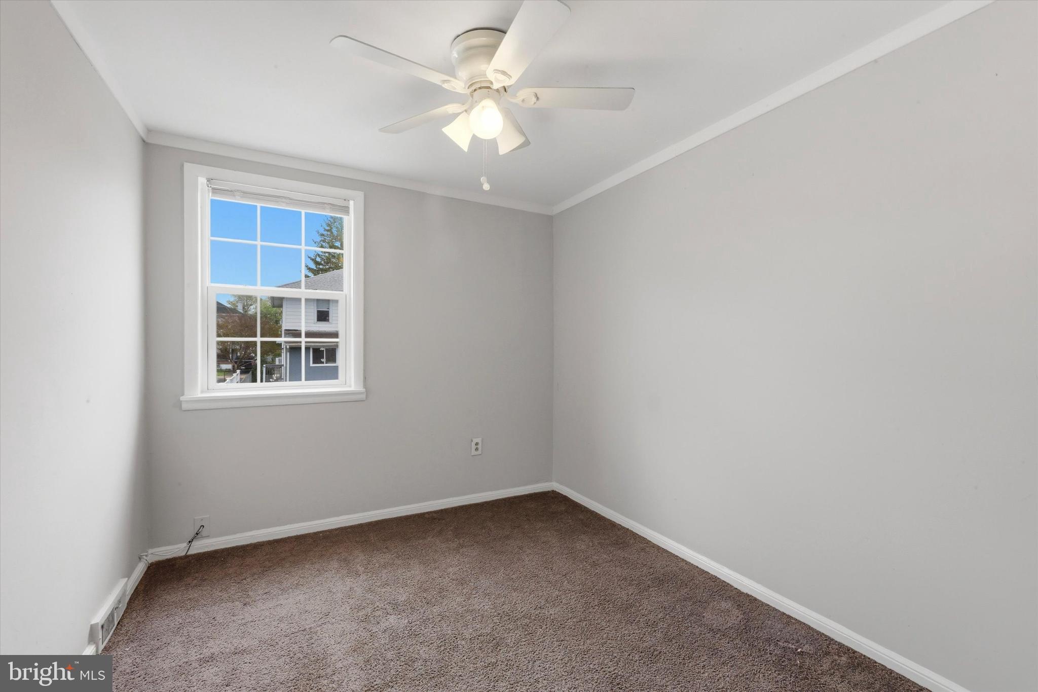 151 Chadwick Avenue Marcus Hook, PA 19061 - Photo 8 of 14 an empty room with a window and a fan