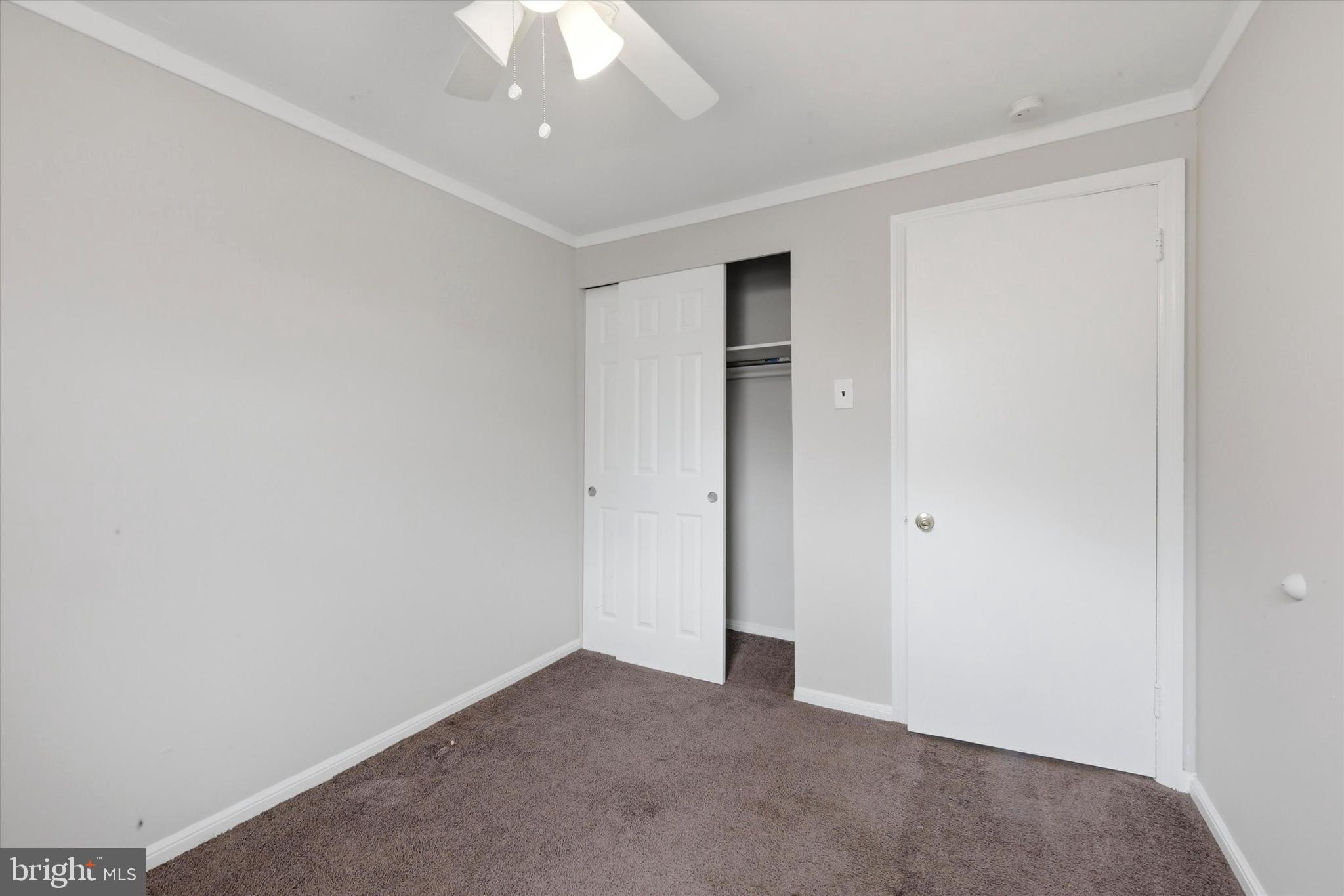 151 Chadwick Avenue Marcus Hook, PA 19061 - Photo 9 of 14 an empty room with a ceiling fan