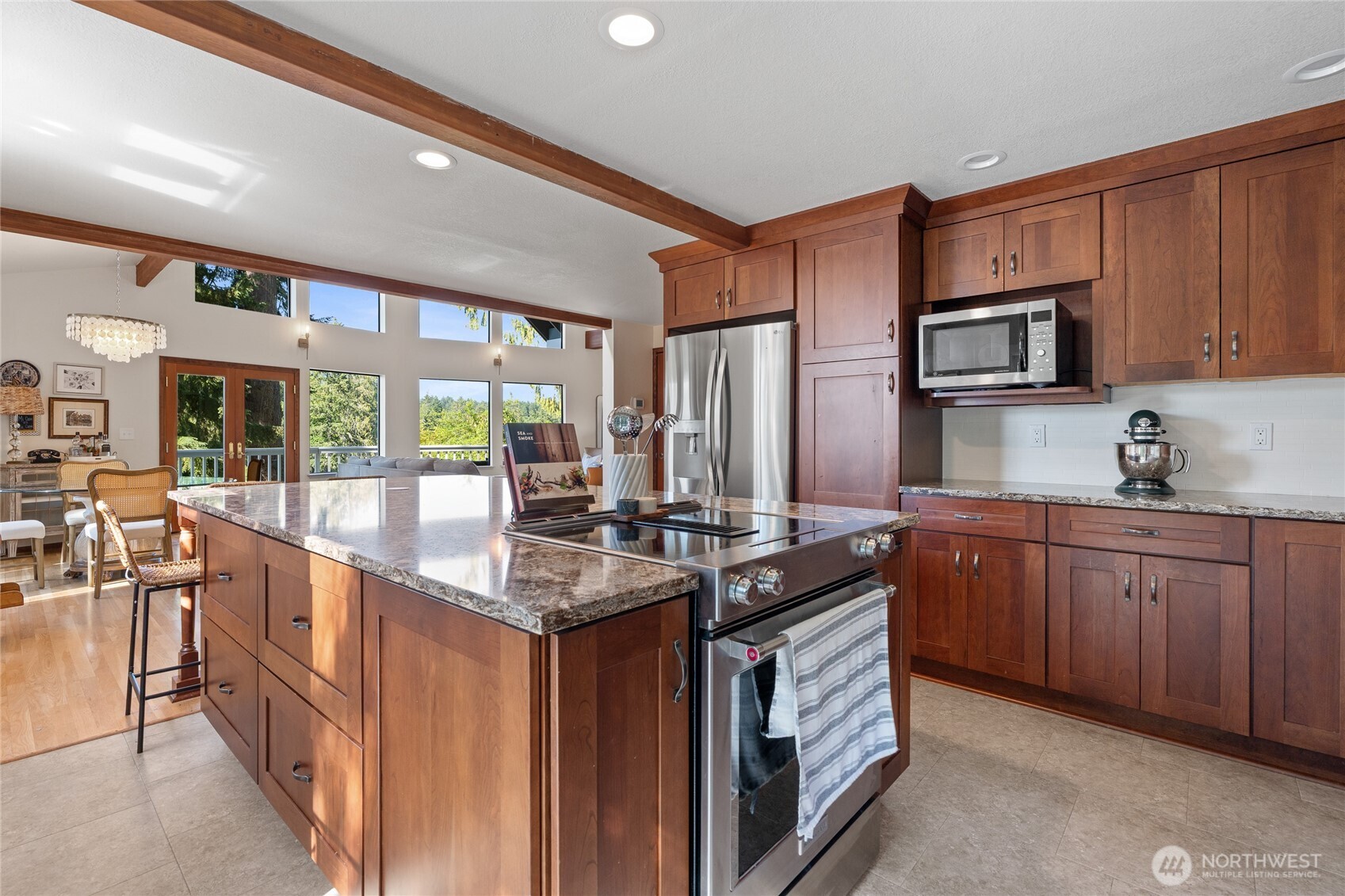 19709 Whiteman Cove Road Southwest Longbranch, WA 98351 - Photo 14 of 40 a kitchen with stainless steel appliances granite countertop a stove a sink and a microwave