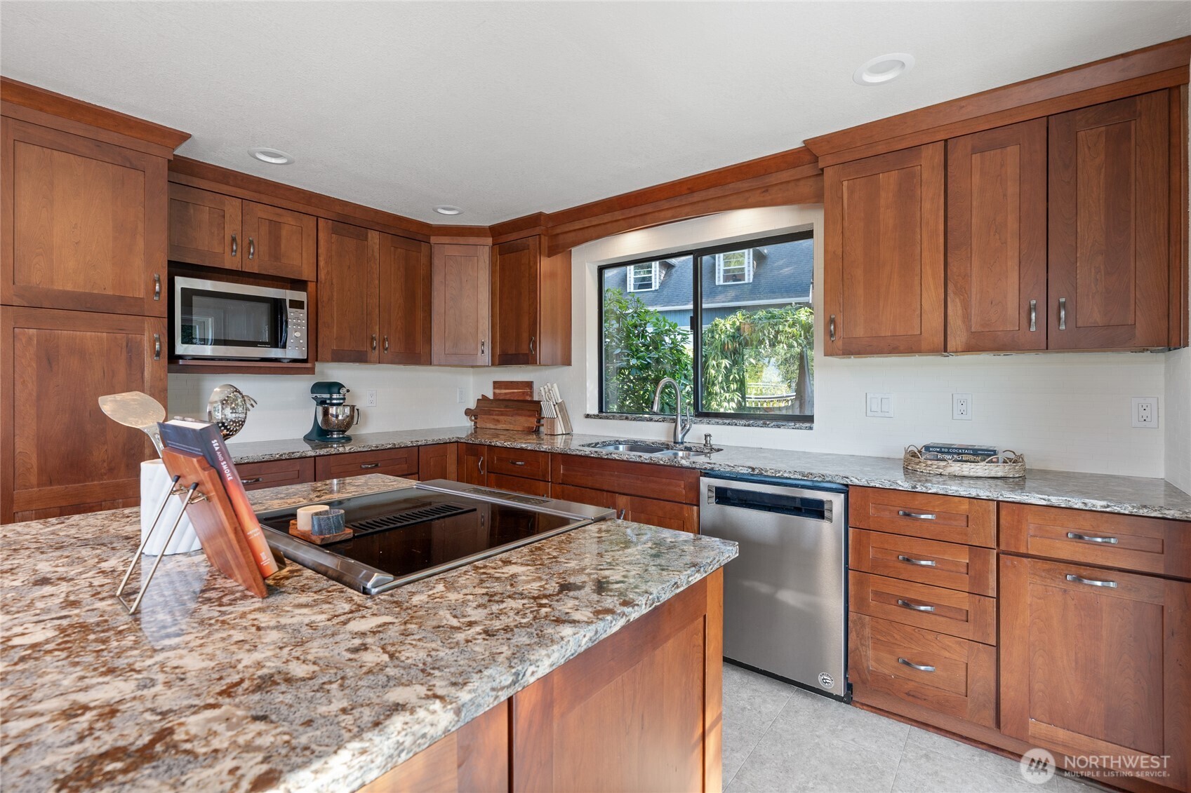 19709 Whiteman Cove Road Southwest Longbranch, WA 98351 - Photo 15 of 40 a kitchen with stainless steel appliances granite countertop a sink stove and microwave