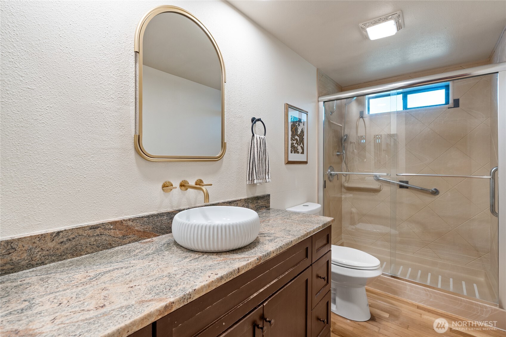 19709 Whiteman Cove Road Southwest Longbranch, WA 98351 - Photo 17 of 40 a bathroom with a granite countertop sink a toilet and shower