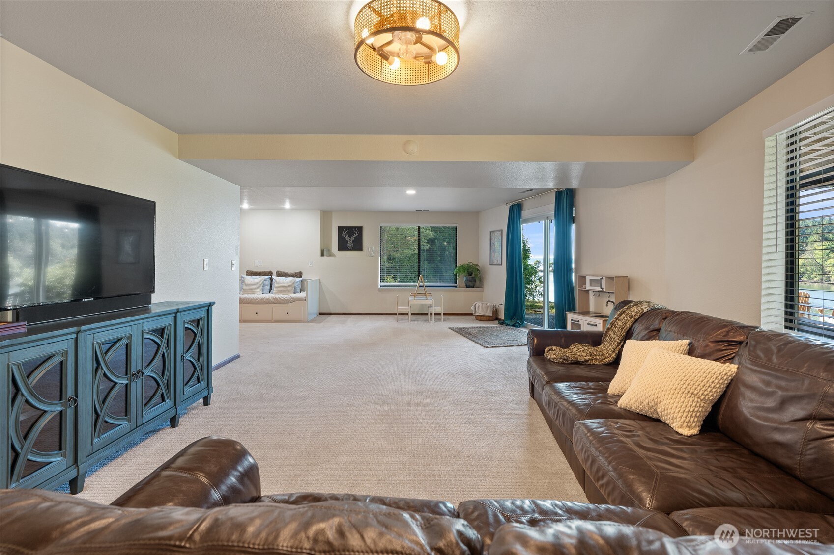 19709 Whiteman Cove Road Southwest Longbranch, WA 98351 - Photo 25 of 40 a living room with furniture and a flat screen tv