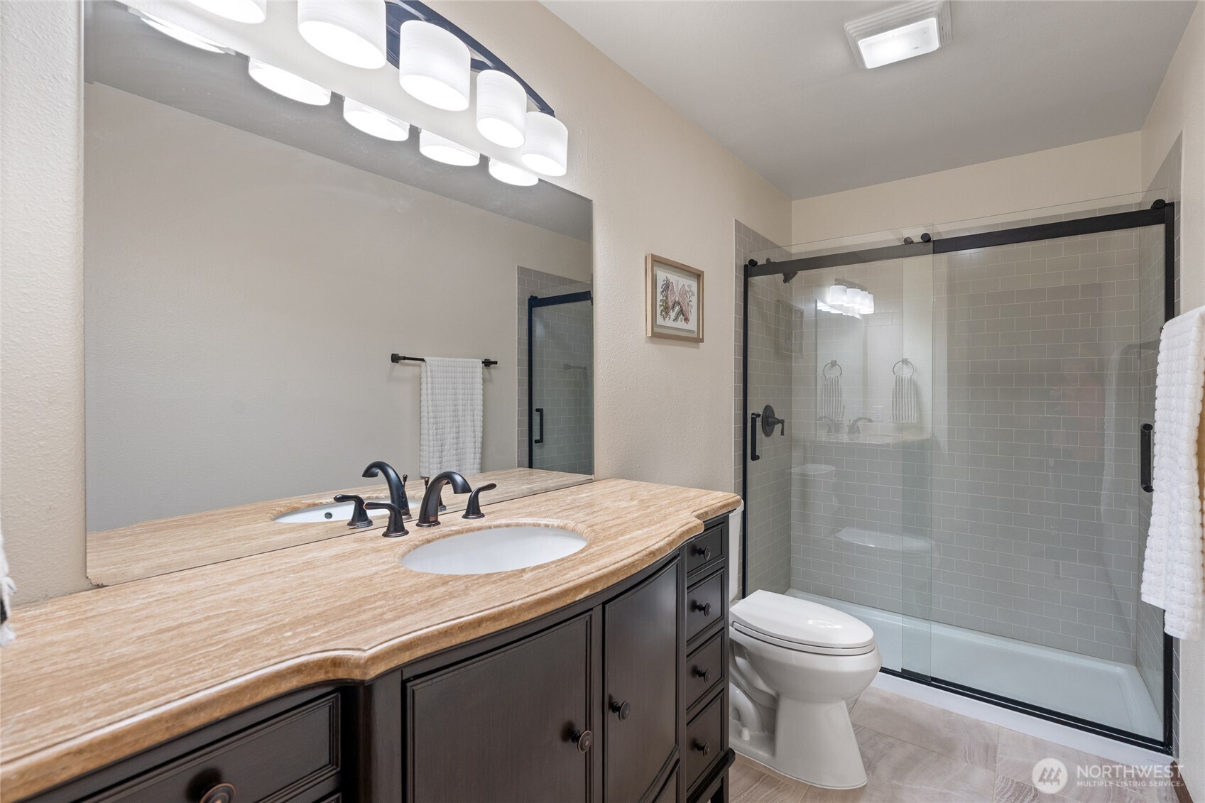 19709 Whiteman Cove Road Southwest Longbranch, WA 98351 - Photo 29 of 40 a bathroom with a sink a toilet and shower