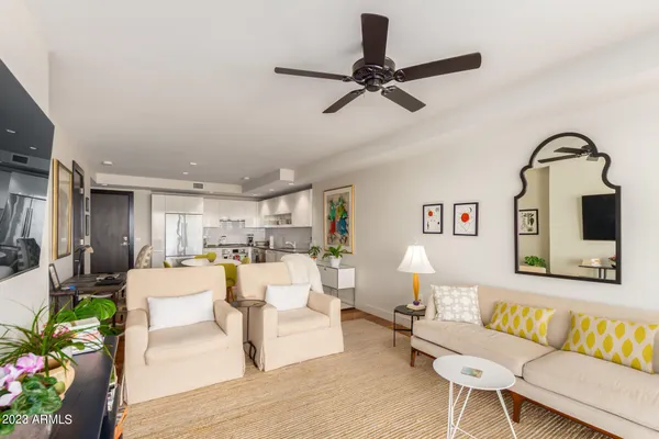 a living room with furniture and a view of kitchen