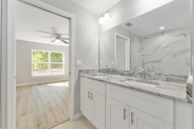 a bathroom with a granite countertop sink mirror and double