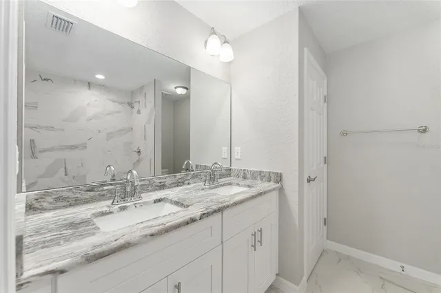 a bathroom with a sink double vanity and a mirror