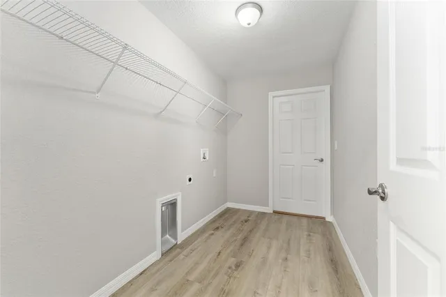 a view of a room with wooden floor