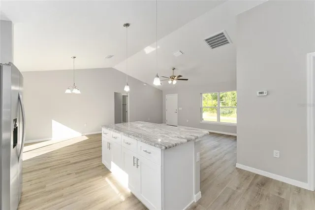 a bathroom with a granite countertop sink a toilet and a large mirror