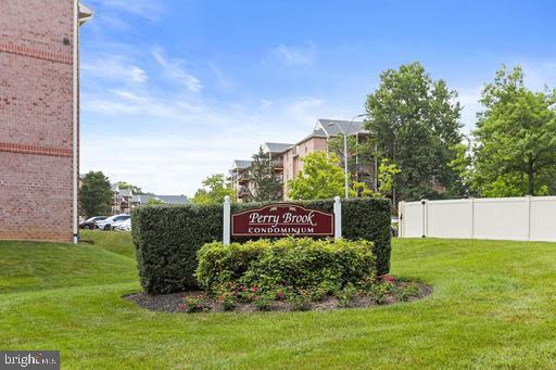 a view of a sign in front of a house with a big yard