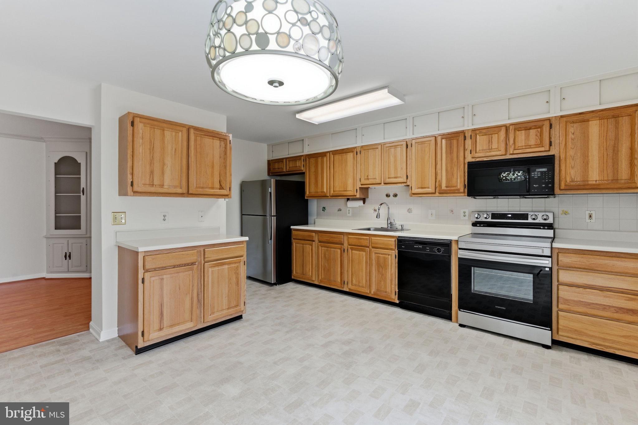 3901 Darleigh Road, Unit 3G Baltimore, MD 21236 - Photo 11 of 41 a kitchen with stainless steel appliances a stove sink and microwave