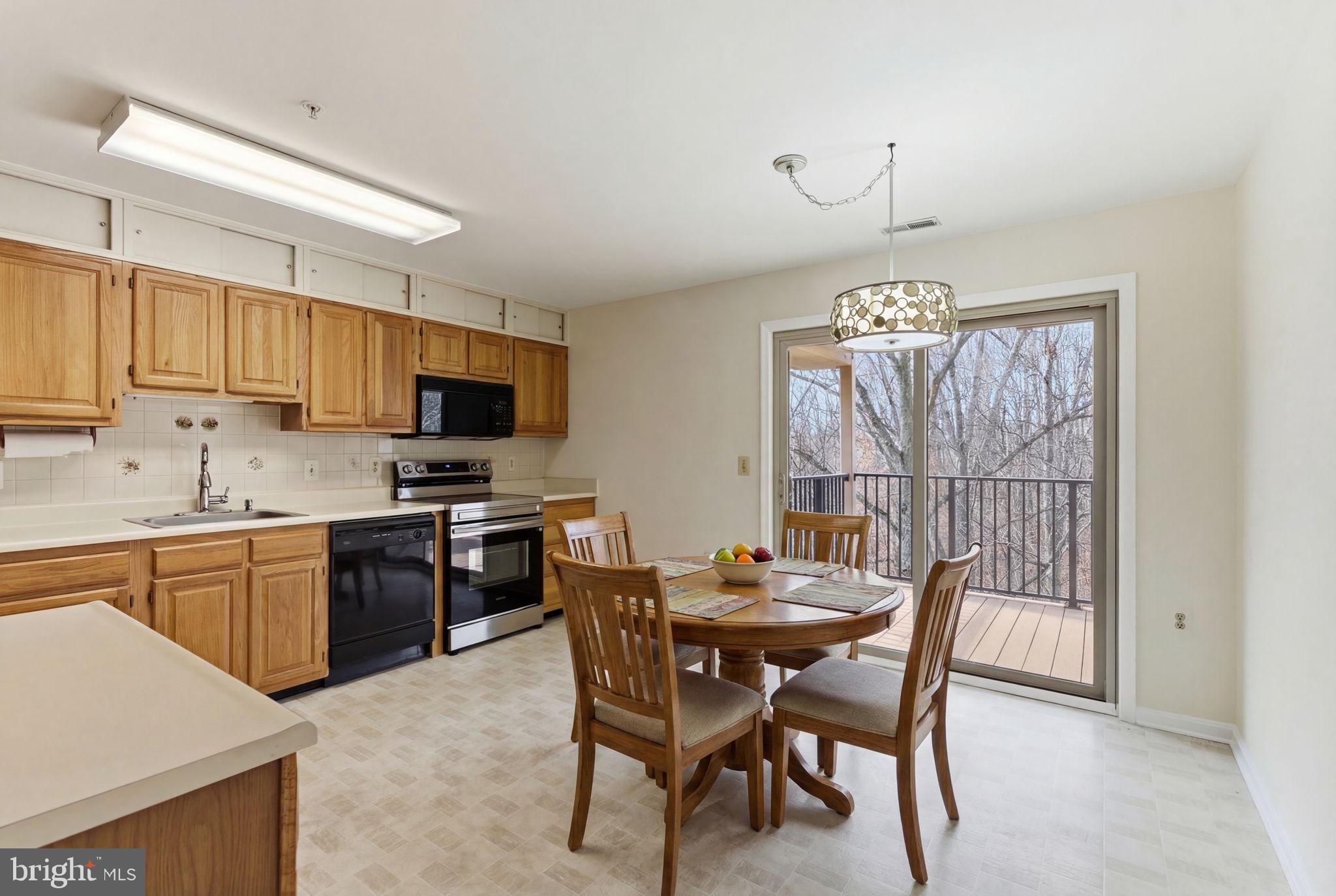 3901 Darleigh Road, Unit 3G Baltimore, MD 21236 - Photo 13 of 41 a kitchen with a dining table and chairs