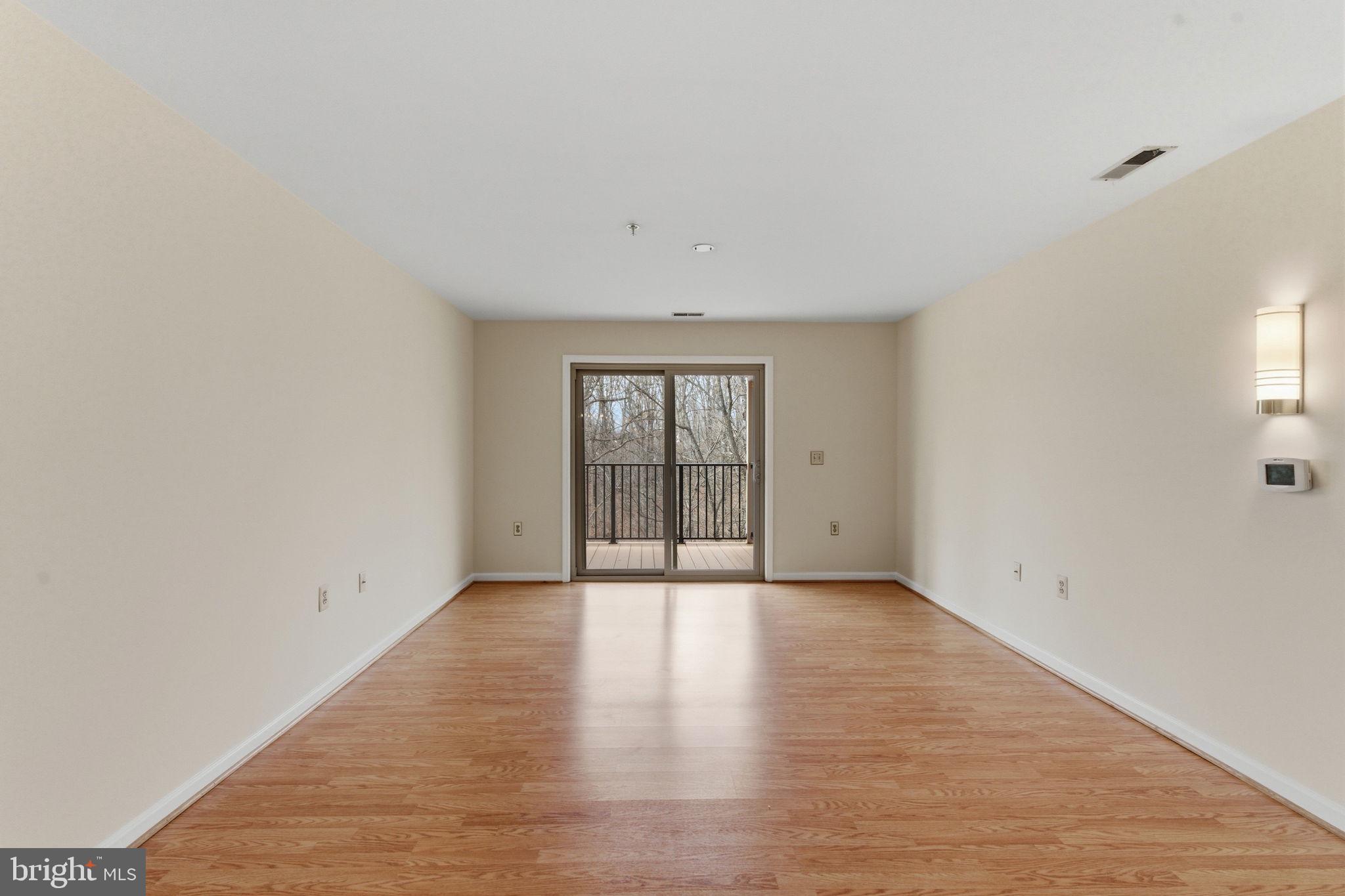 3901 Darleigh Road, Unit 3G Baltimore, MD 21236 - Photo 17 of 41 a view of an empty room with wooden floor and fan