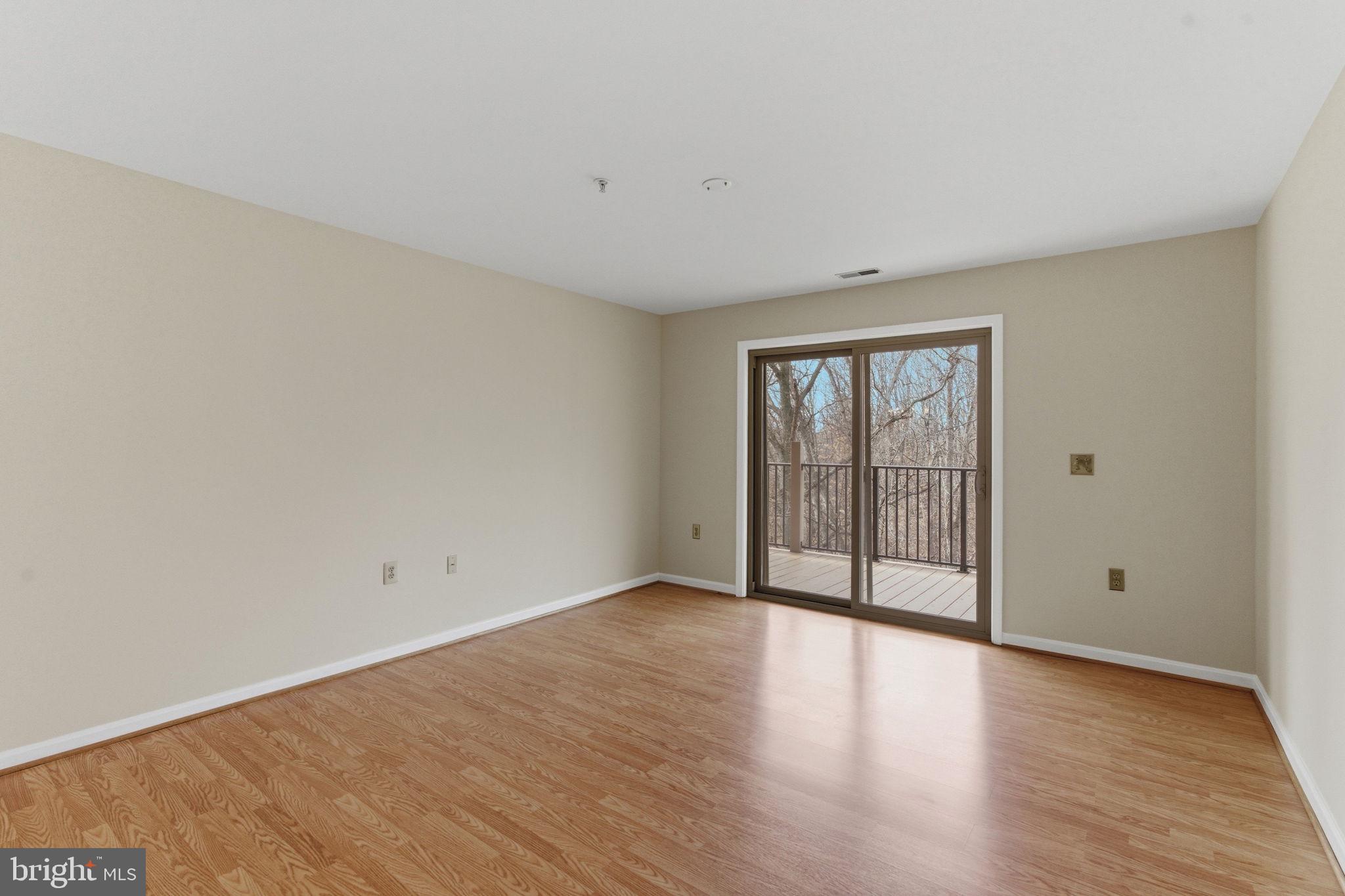 3901 Darleigh Road, Unit 3G Baltimore, MD 21236 - Photo 18 of 41 a view of an empty room with wooden floor and a window