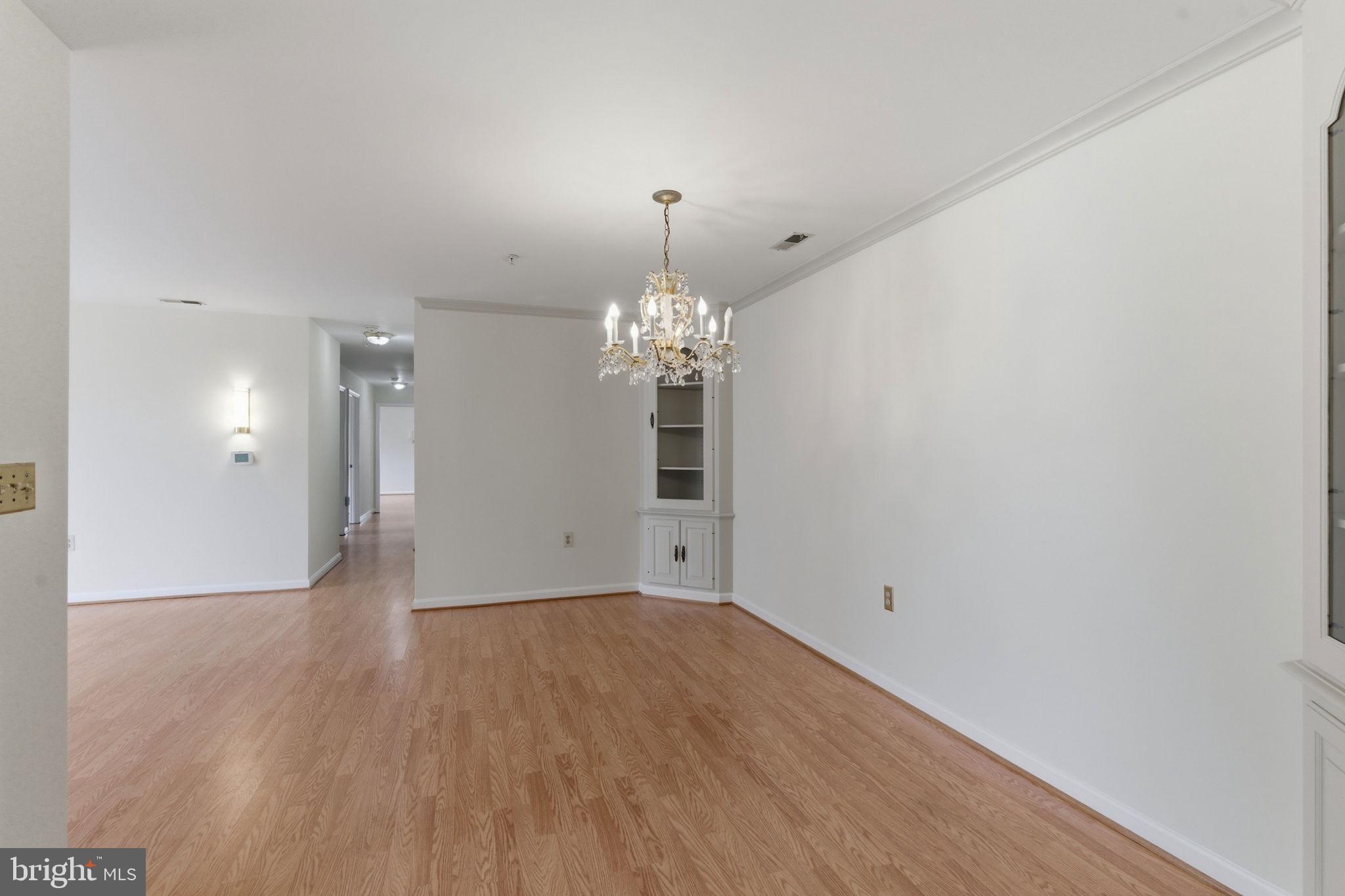 3901 Darleigh Road, Unit 3G Baltimore, MD 21236 - Photo 21 of 41 wooden floor in an empty room with a chandelier