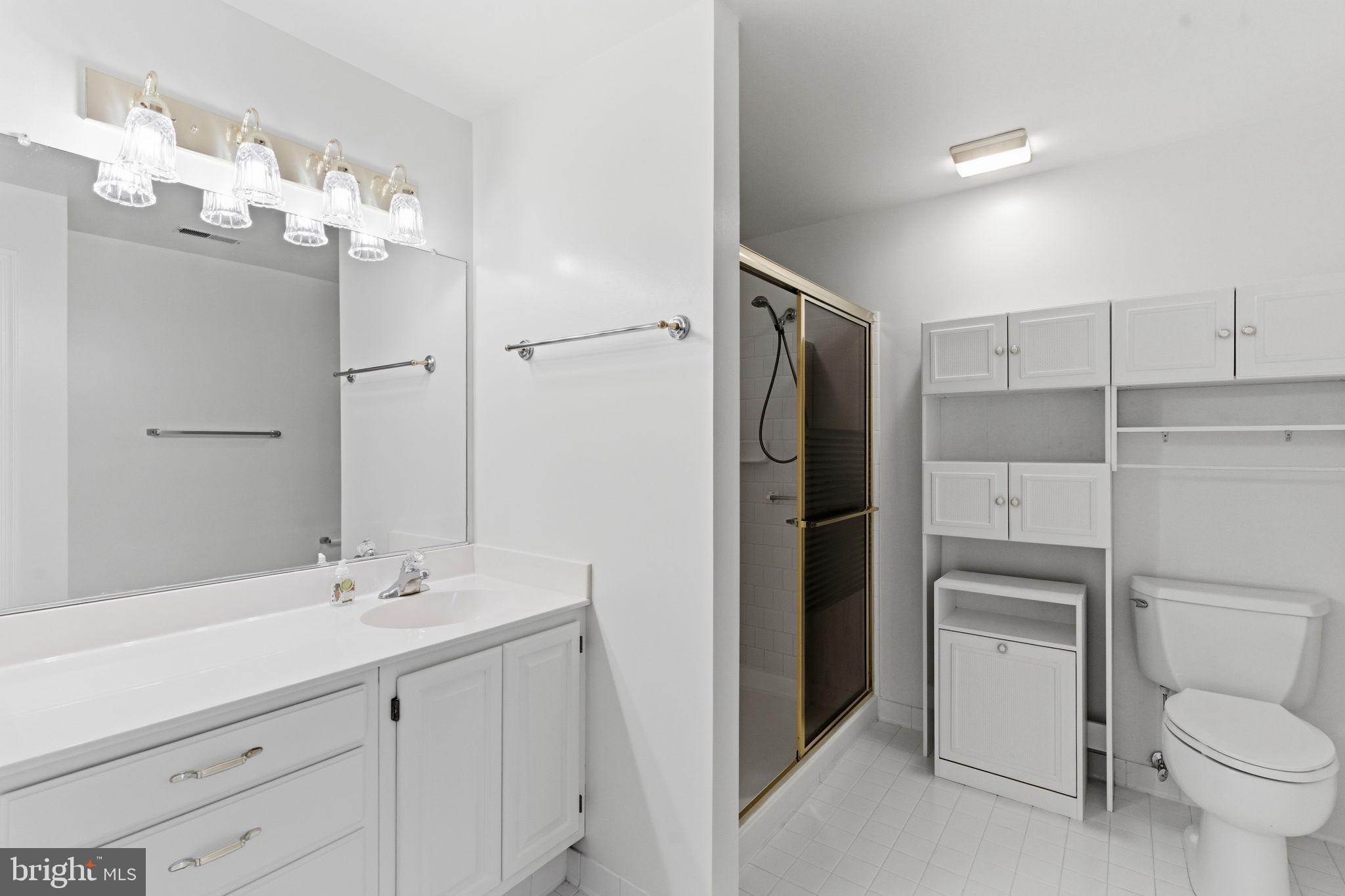 3901 Darleigh Road, Unit 3G Baltimore, MD 21236 - Photo 27 of 41 a bathroom with a double vanity sink toilet and shower