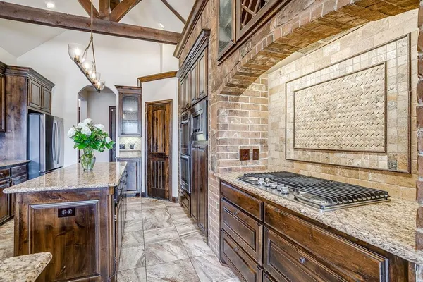 a kitchen with granite countertop center island and stainless steel appliances