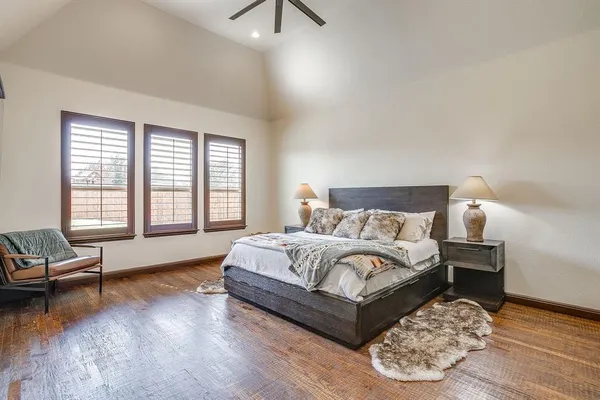 a bedroom with a bed and a painting on the wall