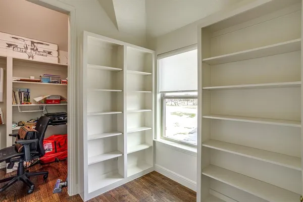 a bedroom with two beds and a chandelier