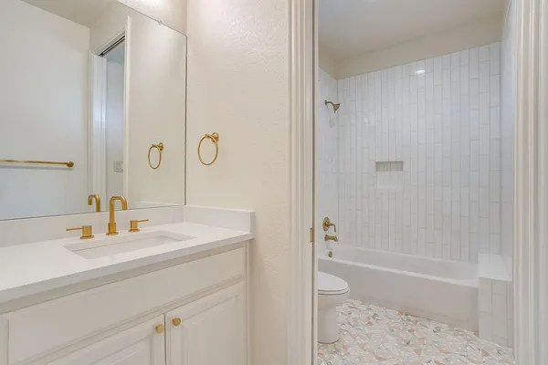 a bathroom with a toilet and bathtub