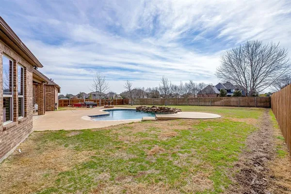 a view of a lake with houses in the back