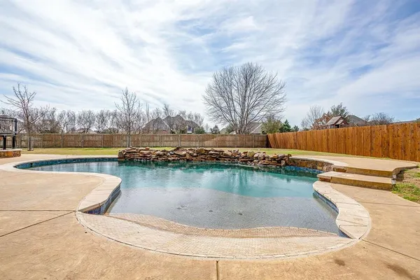 a roof deck with a table and chairs