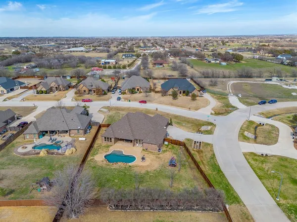 an aerial view of a house with yard swimming pool and ocean view
