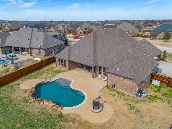 a view of a house with swimming pool and a yard