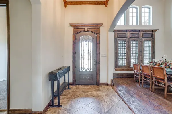a dining room with a window and wooden floor