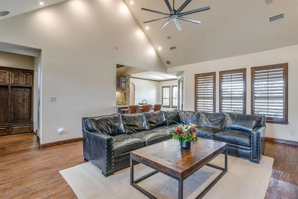 a living room with furniture and wooden floor