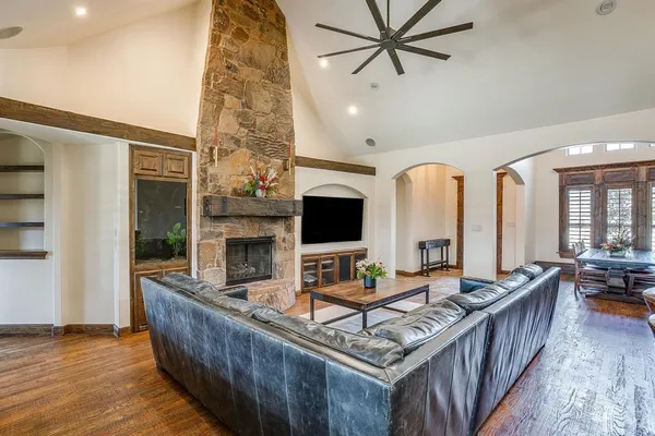 a living room with furniture a fireplace and a flat screen tv