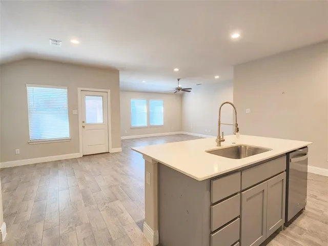 a stove top oven sitting inside of a kitchen