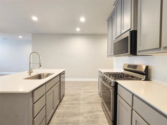 a stove top oven sitting inside of a kitchen