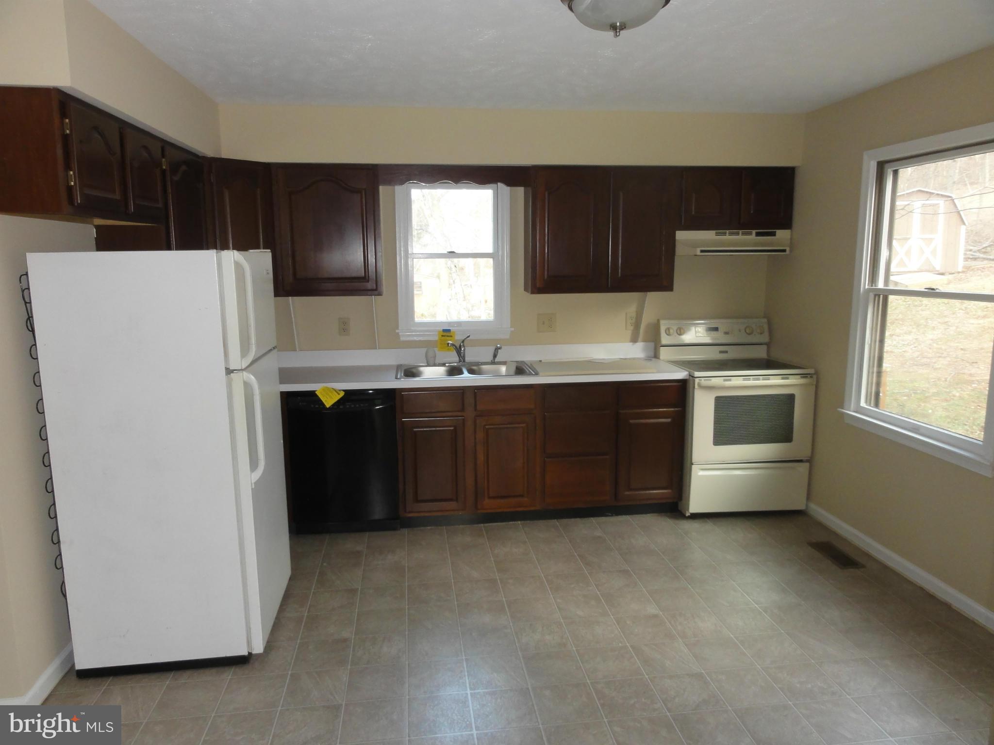 4437 Remount Road Front Royal, VA 22630 - Photo 11 of 22 a kitchen with stainless steel appliances a sink a stove a refrigerator a window