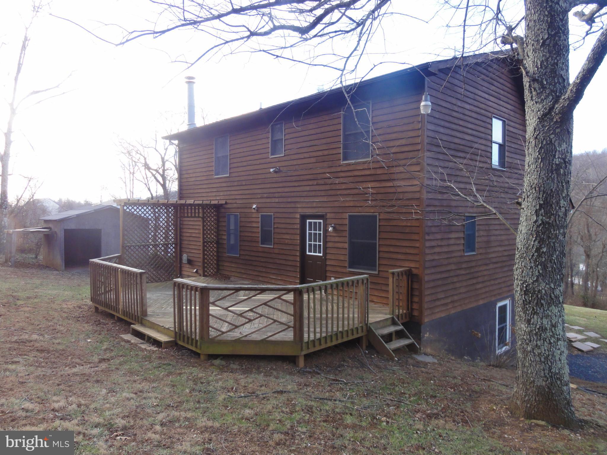 4437 Remount Road Front Royal, VA 22630 - Photo 3 of 22 a brick house with a small yard and a large tree