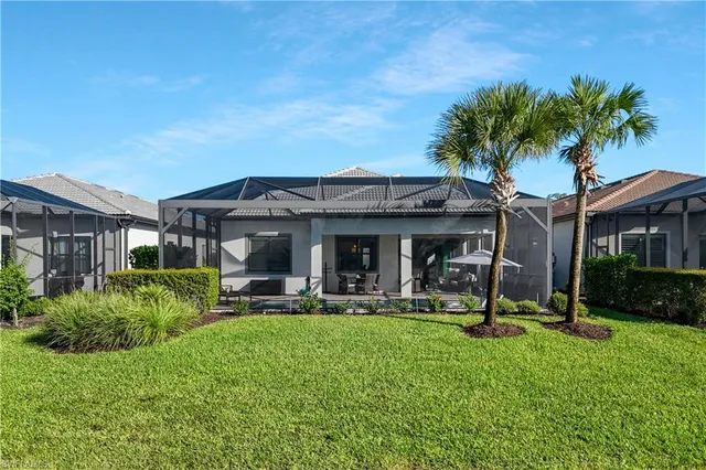 a view of a house with backyard porch and sitting area