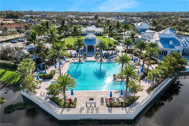an aerial view of a house with a yard lake view