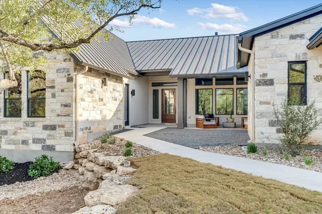 a front view of a house with a yard covered in snow