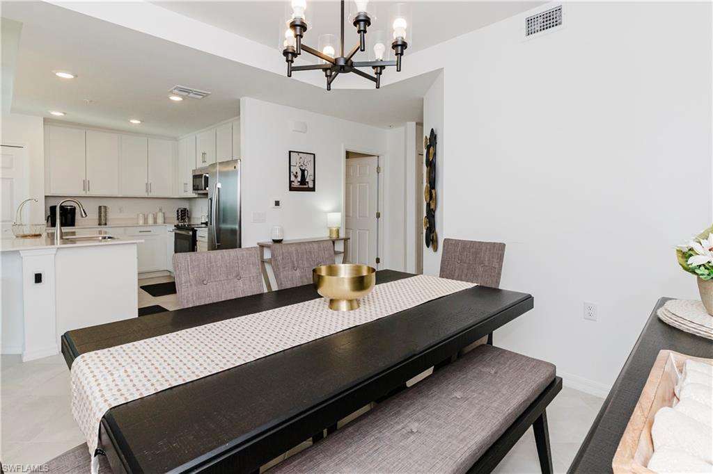 43993 Boardwalk Loop, Unit 1928 Babcock Ranch, FL 33982 - Photo 14 of 50 a living room with stainless steel appliances kitchen island granite countertop furniture and a dining table