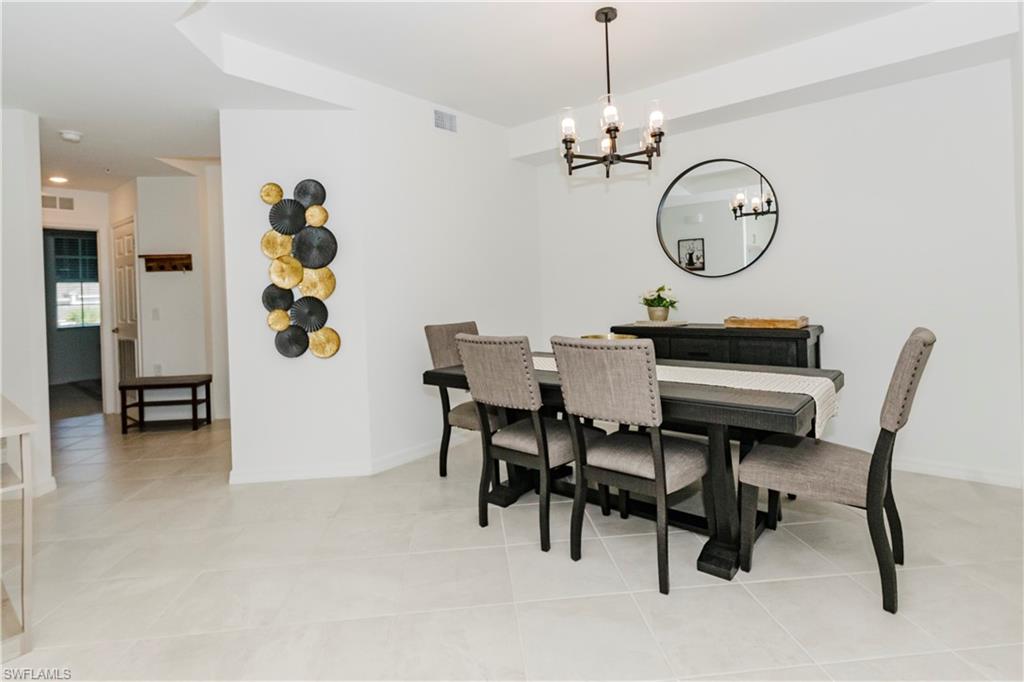 43993 Boardwalk Loop, Unit 1928 Babcock Ranch, FL 33982 - Photo 15 of 50 a view of a dining room with furniture and a chandelier