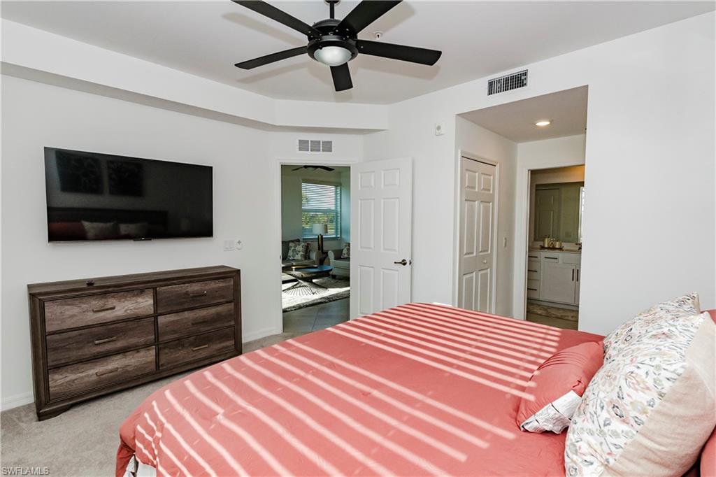 43993 Boardwalk Loop, Unit 1928 Babcock Ranch, FL 33982 - Photo 16 of 50 a bedroom with a bed and a flat screen tv