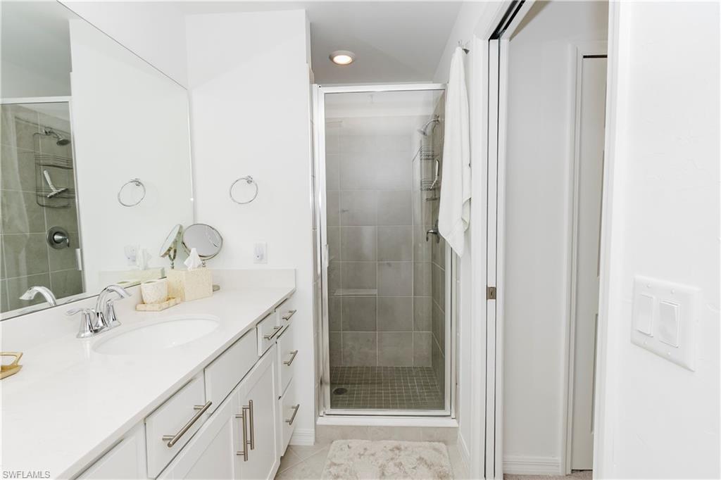 43993 Boardwalk Loop, Unit 1928 Babcock Ranch, FL 33982 - Photo 18 of 50 a bathroom with a shower sink and mirror