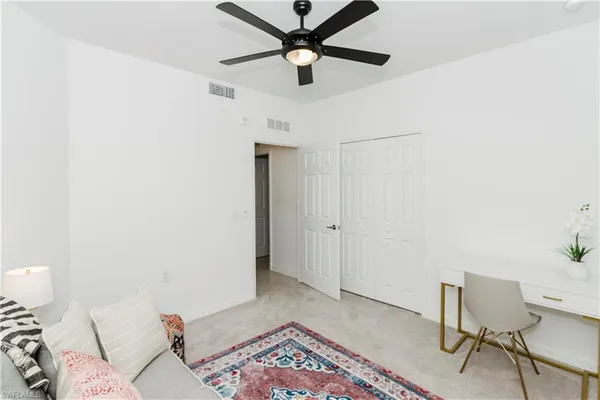 a living room with a bed and a rug