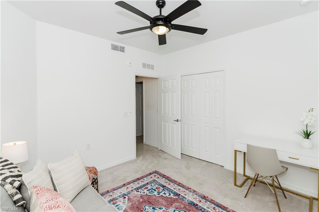 43993 Boardwalk Loop, Unit 1928 Babcock Ranch, FL 33982 - Photo 23 of 50 a living room with a bed and a rug