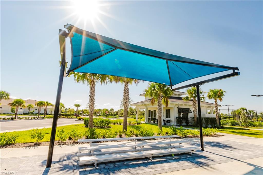 43993 Boardwalk Loop, Unit 1928 Babcock Ranch, FL 33982 - Photo 35 of 50 a view of swimming pool with a table and chairs under an umbrella